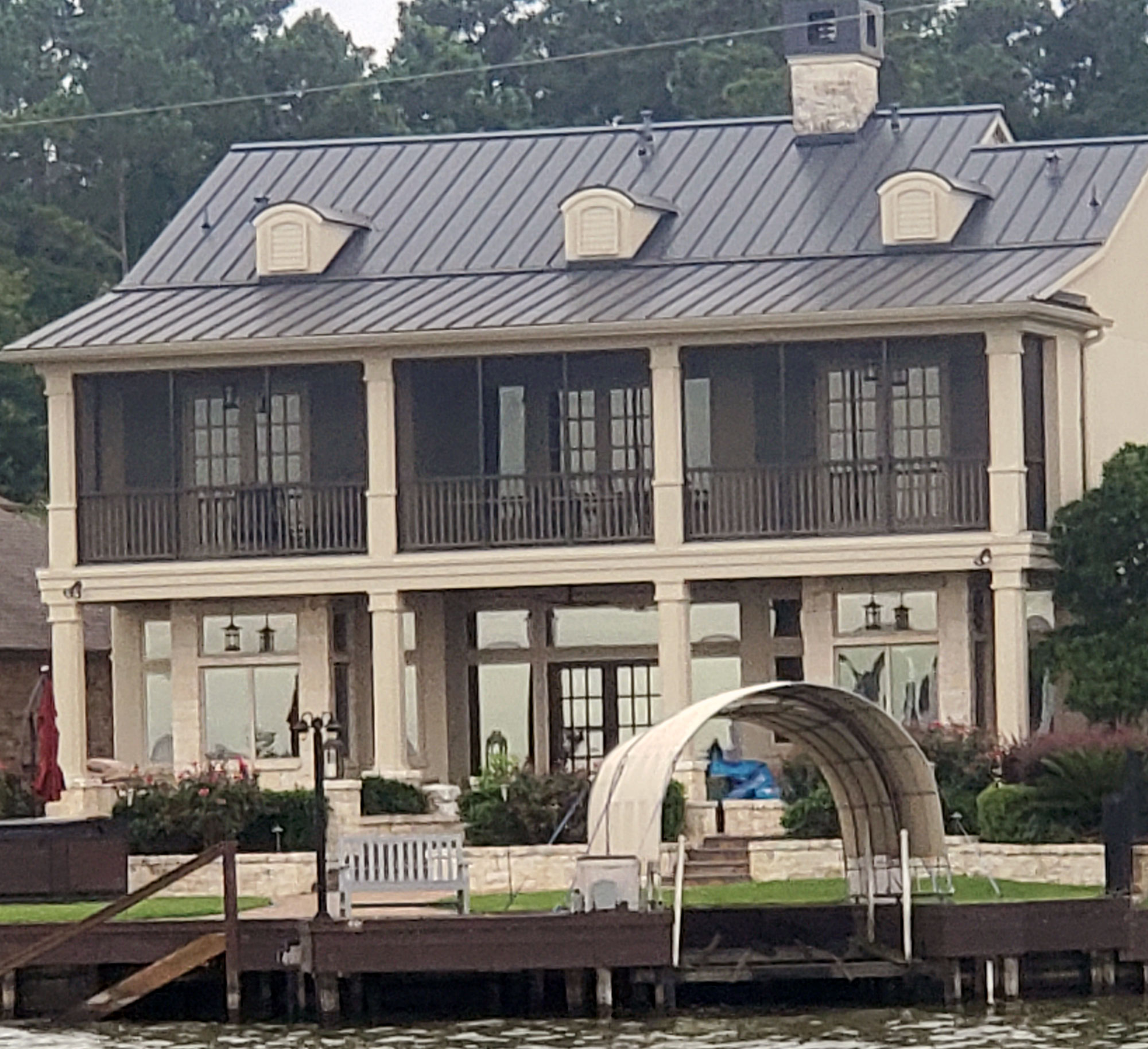 Homeowner meeting with a patio enclosure specialist to plan their custom outdoor living space