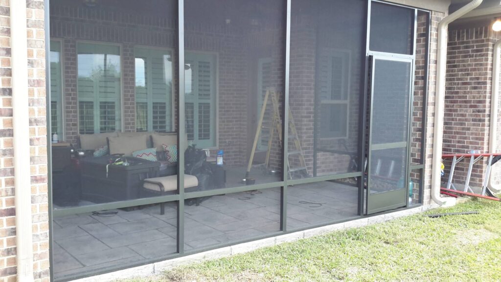 Bronze colored screen wall patio enclosure with aluminum framing by 21st Century Sunrooms Houston TX