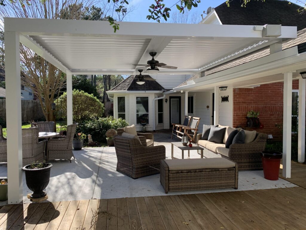 Beautiful custom outdoor living space with louvered roof and comfortable seating showcasing 21st Century Sunrooms' commitment to creating spaces homeowners love