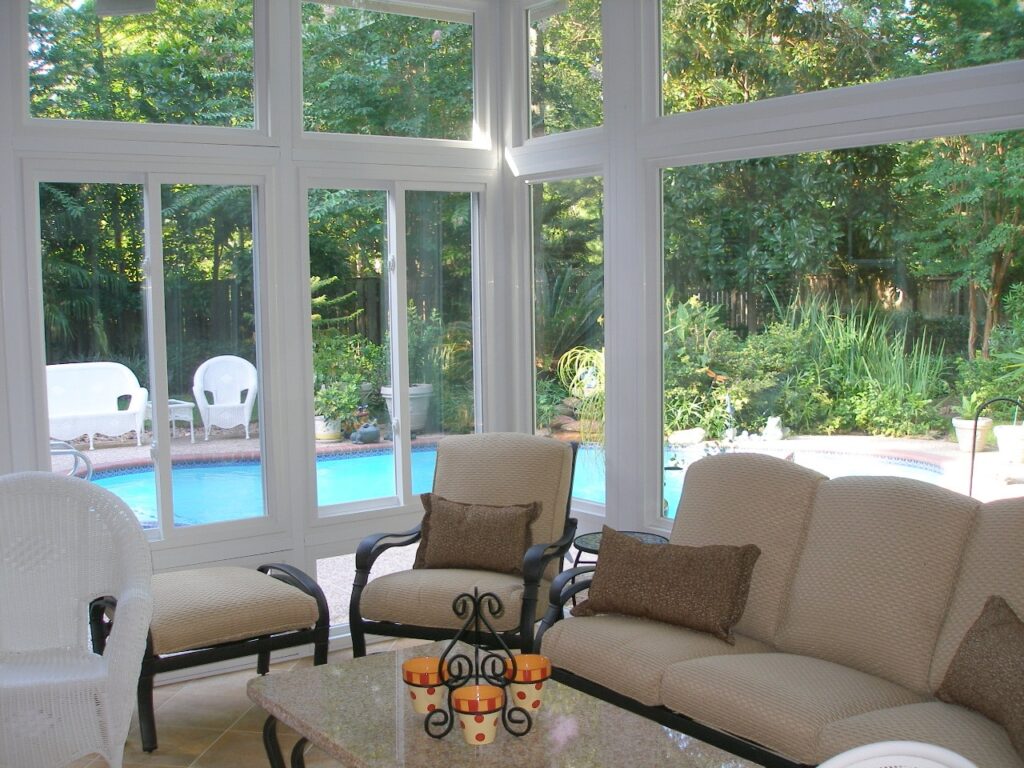 Custom sunroom addition with natural light and comfortable furniture showing how sunrooms expand usable living space in Houston homes