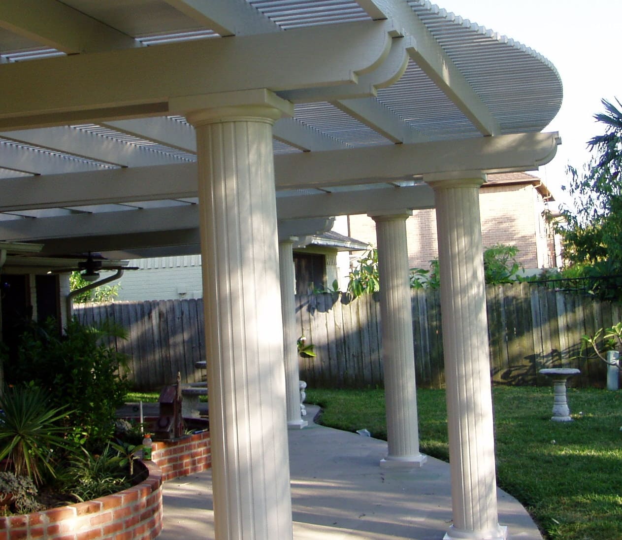 Lattice arbor pergola with decorative lattice top creating filtered shade by 21st Century Sunrooms Houston TX