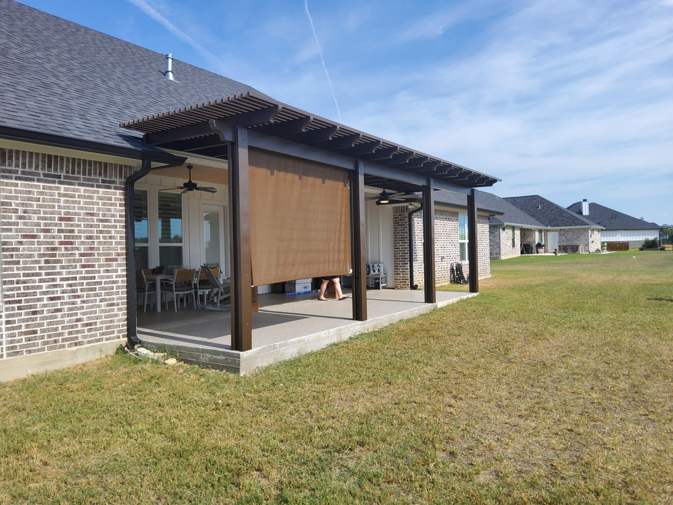 Pergola installed in landscaped backyard setting creating outdoor focal point by 21st Century Sunrooms Houston TX