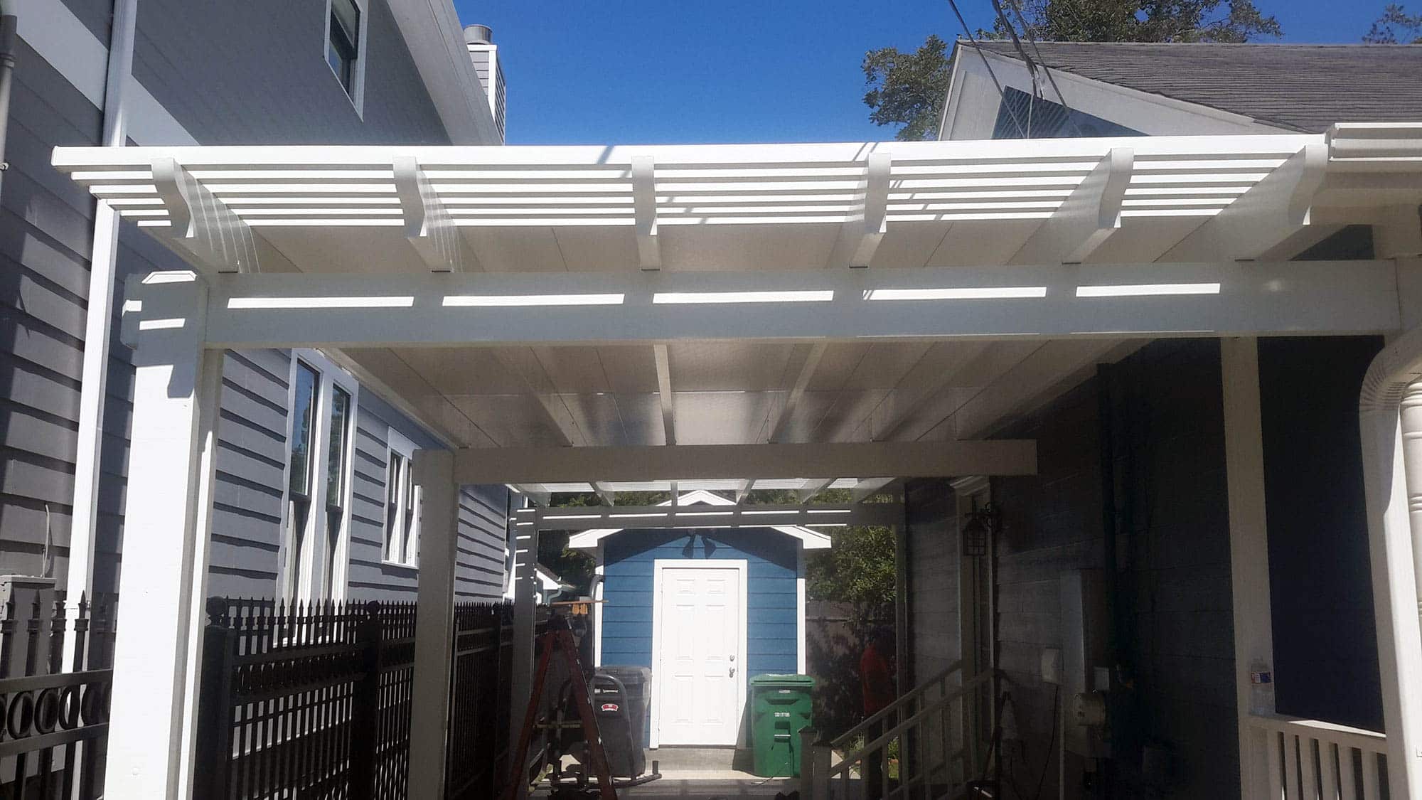 Pergola with solid roof panels providing full shade and weather protection by 21st Century Sunrooms Houston TX