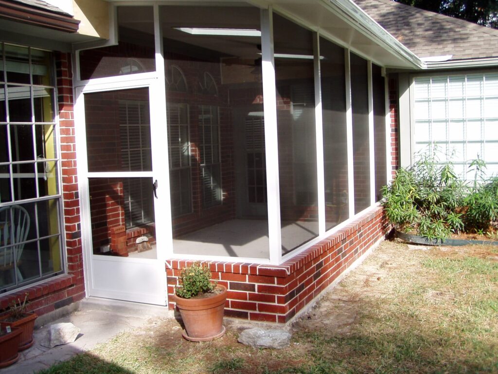 Screen room enclosure with aluminum frame and mesh screening providing bug-free space by 21st Century Sunrooms Houston TX