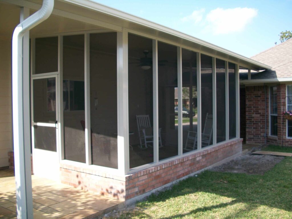 Screen room enclosures with mesh screening and aluminum posts creating protected outdoor areas by 21st Century Sunrooms Houston TX