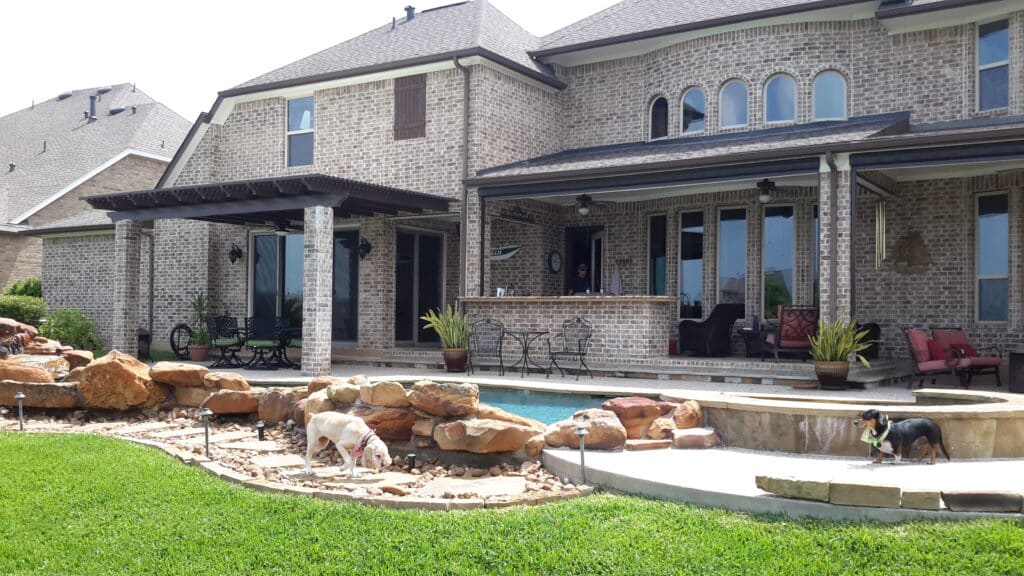 Spanish brown lattice patio cover with decorative design providing filtered shade by 21st Century Sunrooms Houston TX