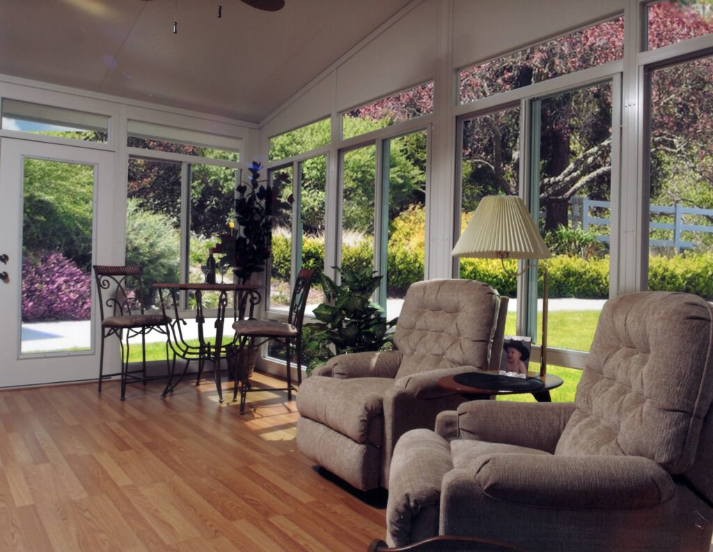 Sunroom with panoramic windows showcasing scenic outdoor views by 21st Century Sunrooms Houston TX